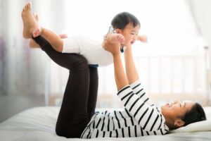 New mom playing with baby. 