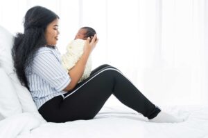 New mom looks into her infant's face.