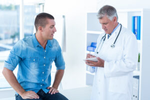 Male patient and male doctor, Writing up treatment for patient.