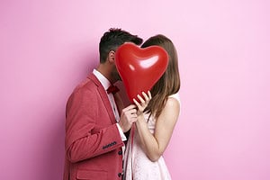 couple and a heart shaped balloon